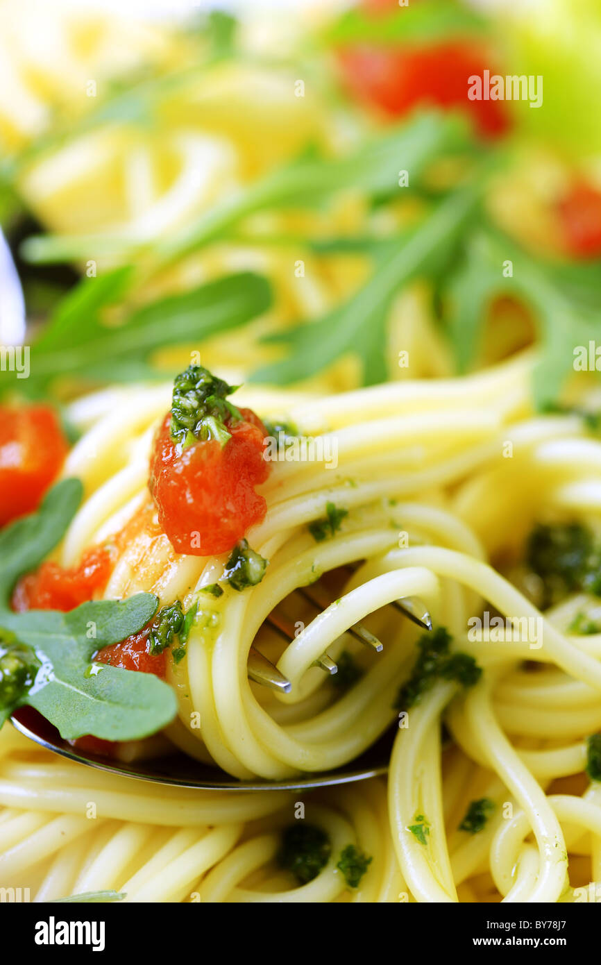 Macro shot of spaghetti twirled around a fork Stock Photo