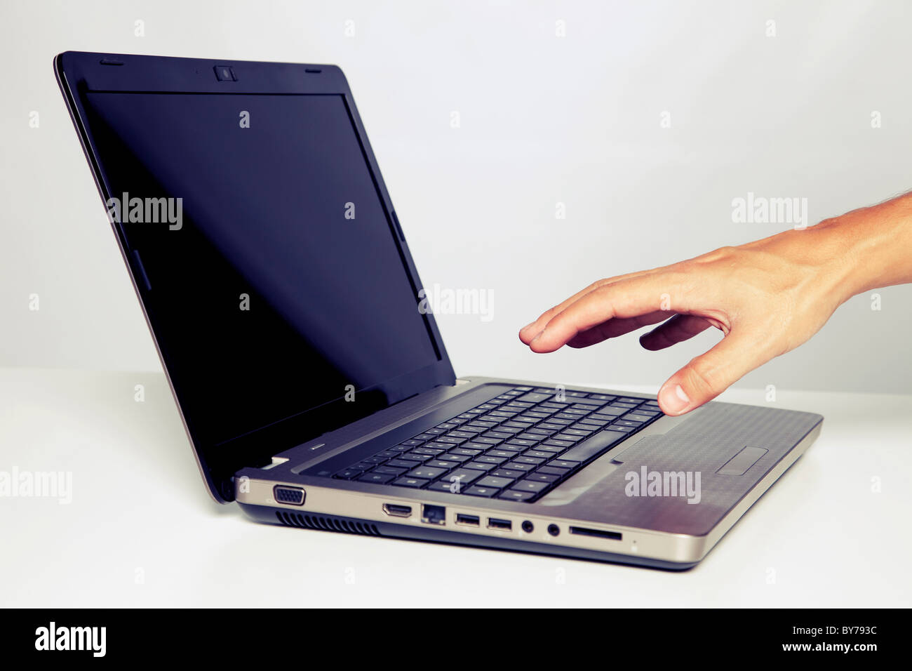 hand gesture next to a laptop with cross processing effect (selective focus) Stock Photo