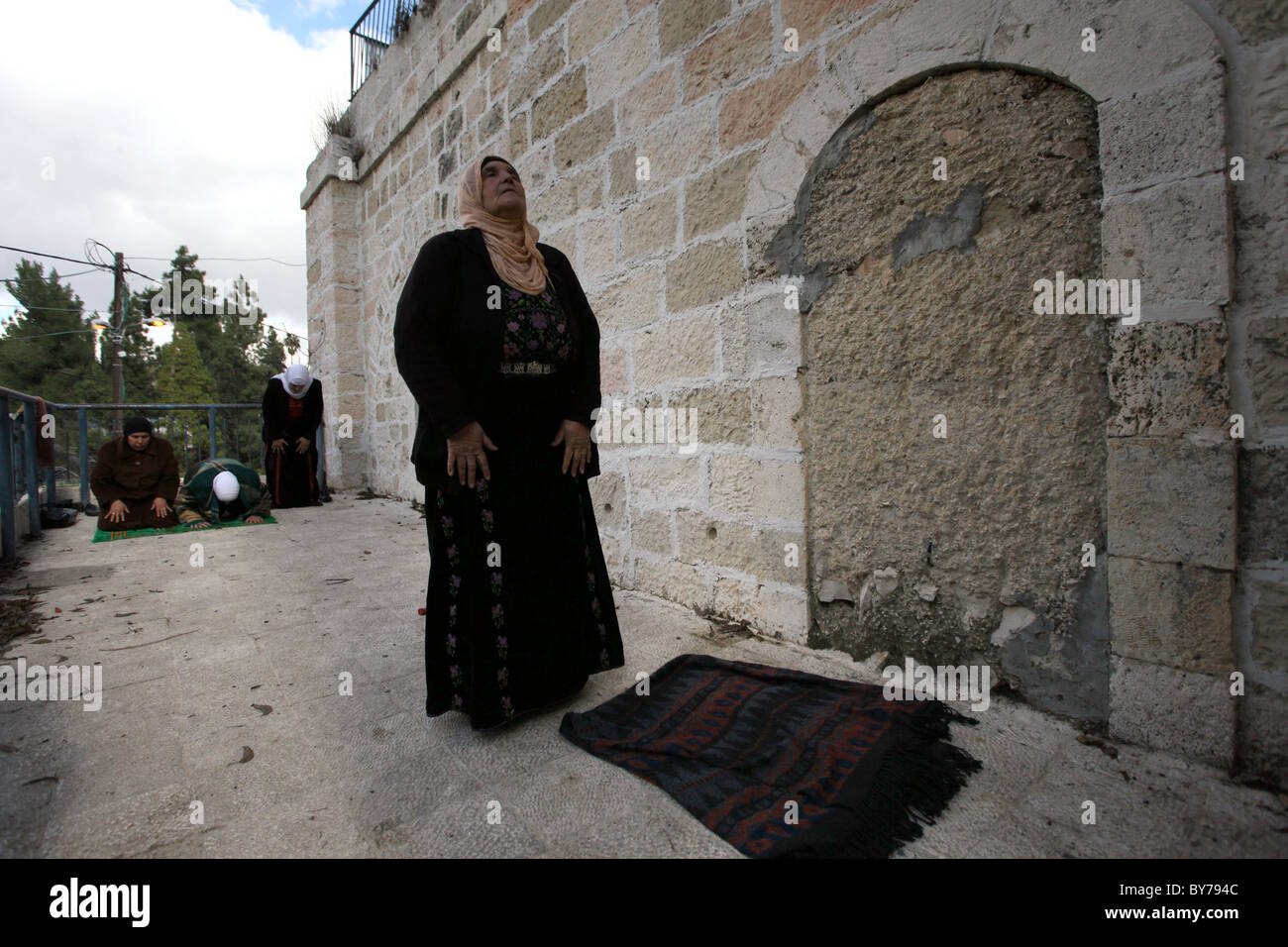 Palestinian women praying as they revisits their family's village in Ein Karem or Ain Kerem a neighborhood in southwest Jerusalem which was depopulated by Arab inhabitants and repopulated by Jewish immigrants during the 1948 Arab-Israeli War. Israel Stock Photo