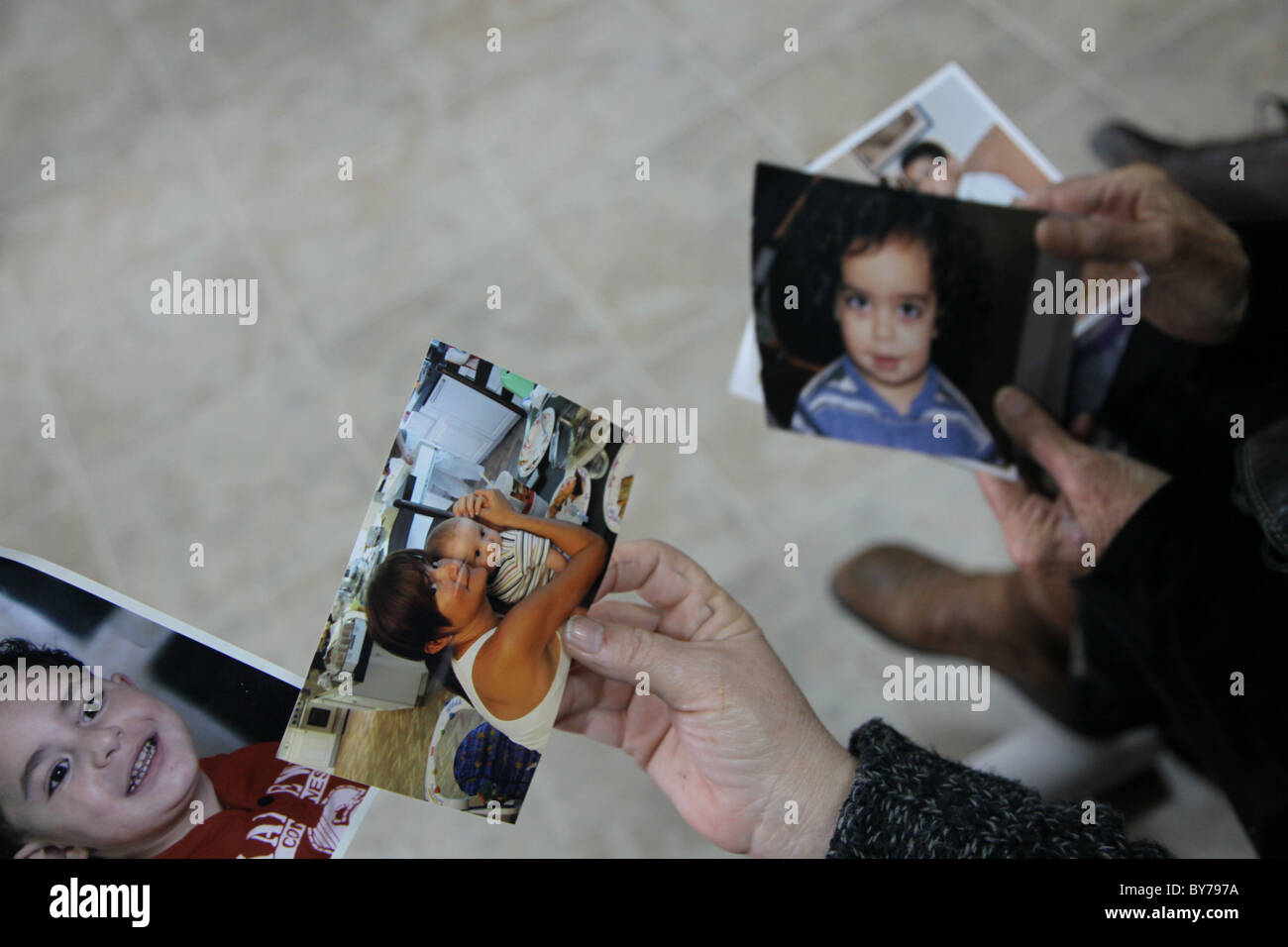 People holding family photographs in Israel Stock Photo
