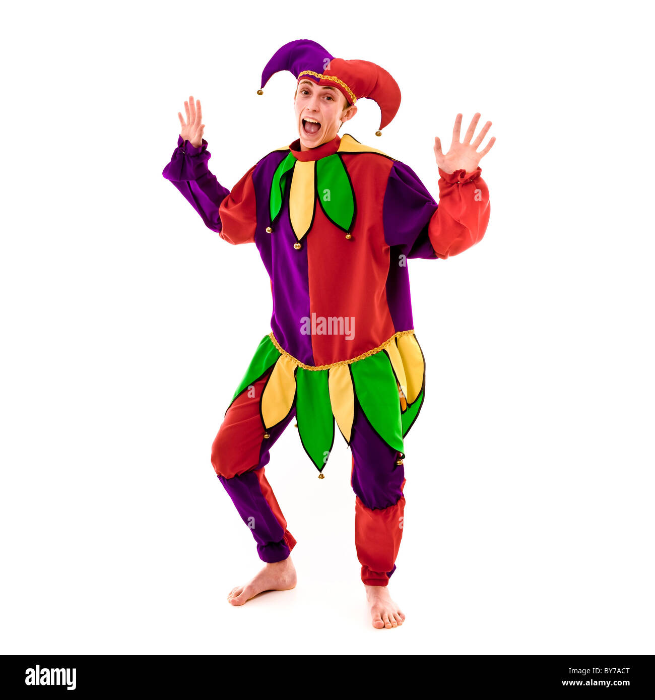Full length studio shot of young caucasian male dressed as a Jester. White background Stock Photo