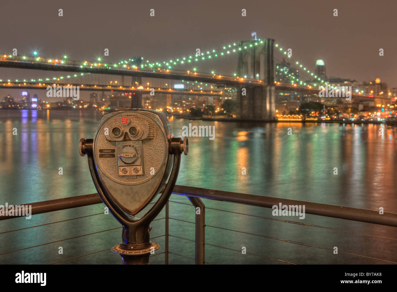 A view from South Street Seaport of the Brooklyn and Manhattan bridges on the East River at night in New York City. Stock Photo
