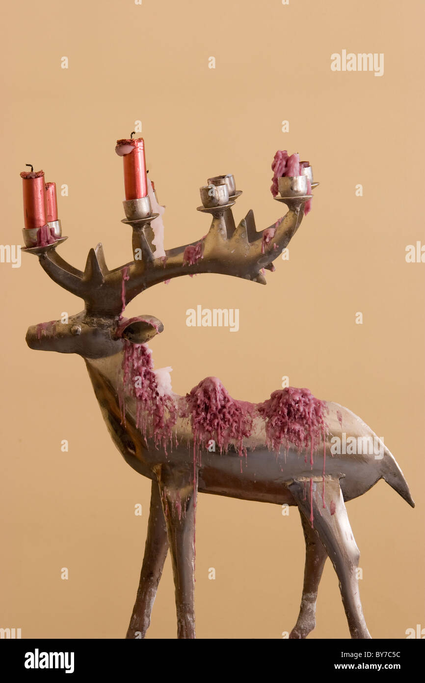 Metal deer candle holder with melted candles and wax Stock Photo Alamy
