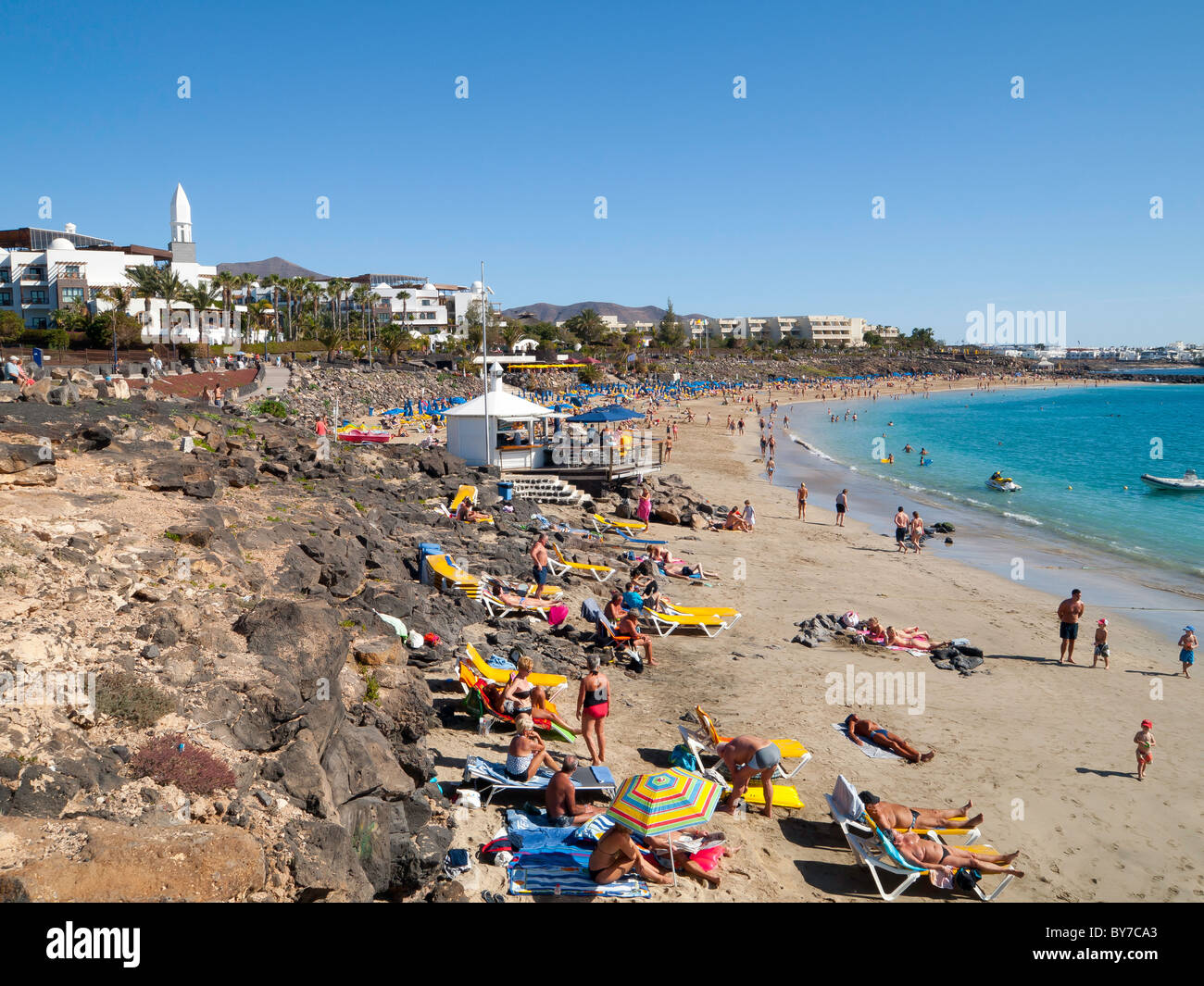 Busy Playa Dorada beach in Playa Blanca Lanzarote on a hot day in early  January Stock Photo - Alamy