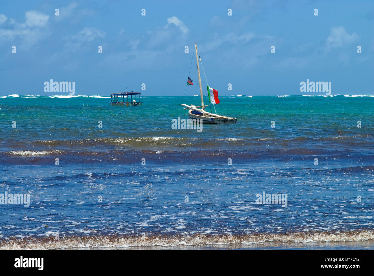 picture postcard image of boat with Kenya flat at Turtle bay, Watamu in Kenya Stock Photo
