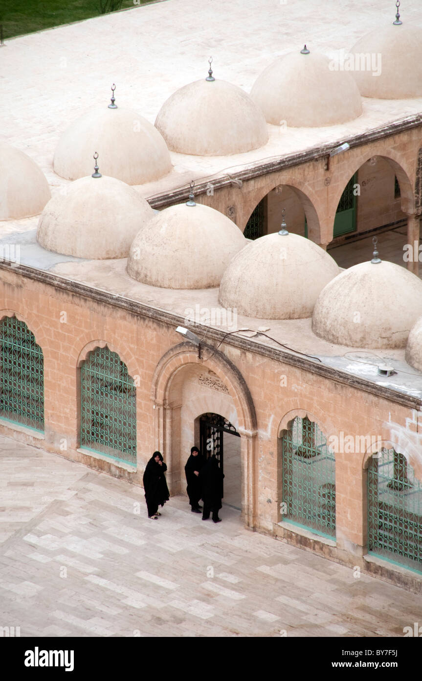 Turkish women in chadors at the entrance of the Halilur Rahman Mosque, or the Great Mosque, in the city of Urfa, eastern Anatolia region, Turkey. Stock Photo