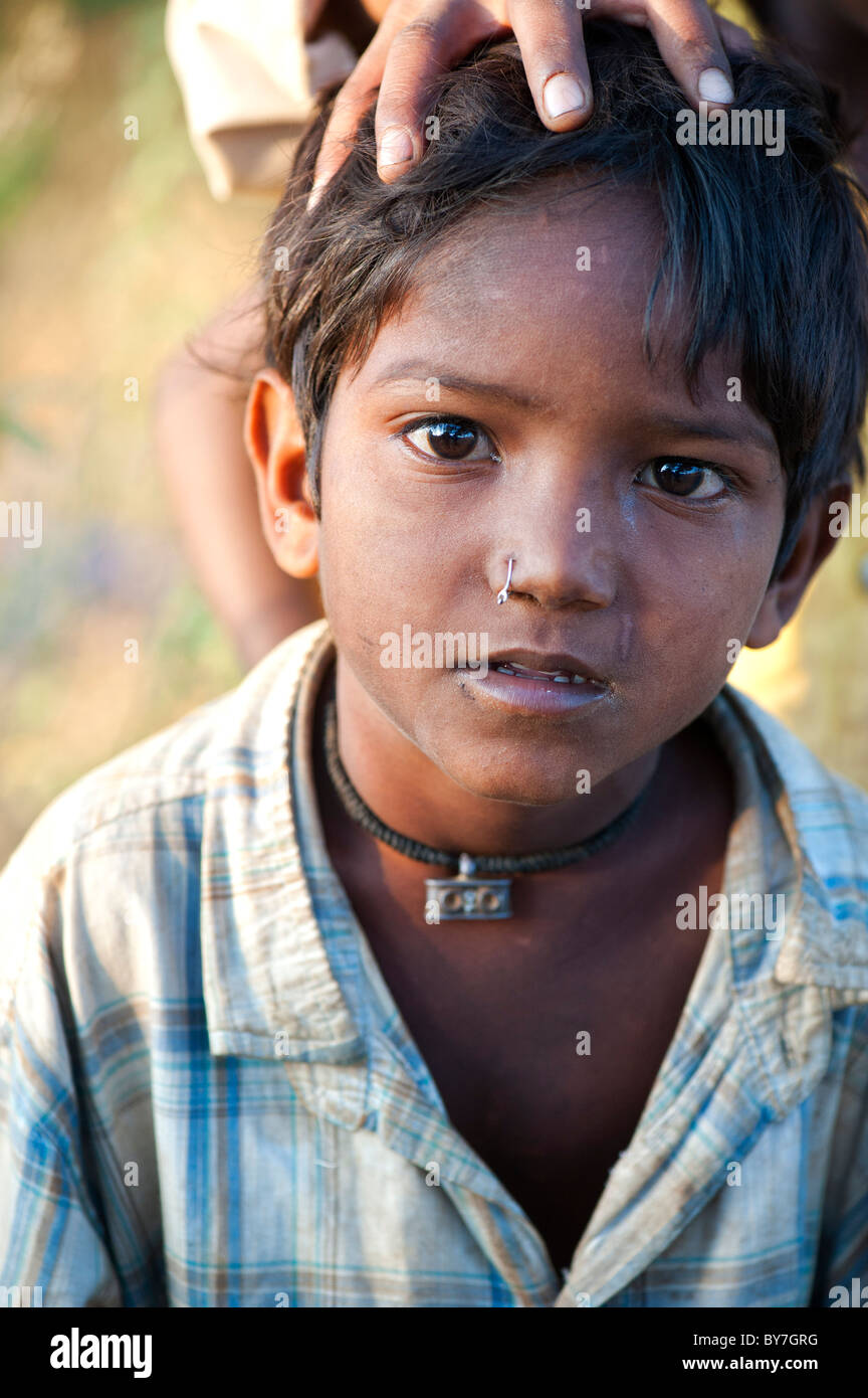 Young poor lower caste Indian street boy with a pierced nose. Andhra Pradesh, India Stock Photo