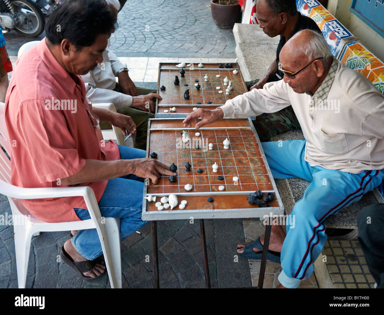 Local Thai people play old traditional Thai chess in public area - slow  life style local people with chess board game concept Stock Photo