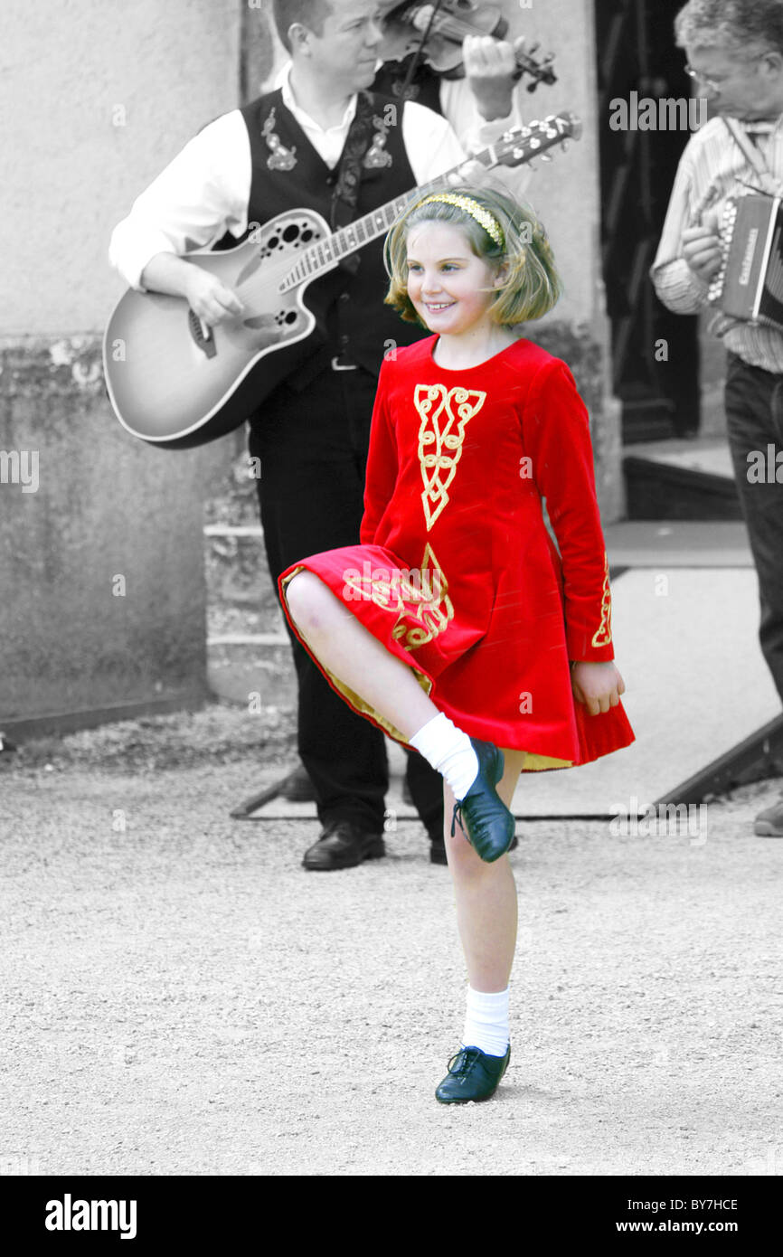 Red Tinted Retro Image of an Irish Teenage Girl dancing a jig Stock