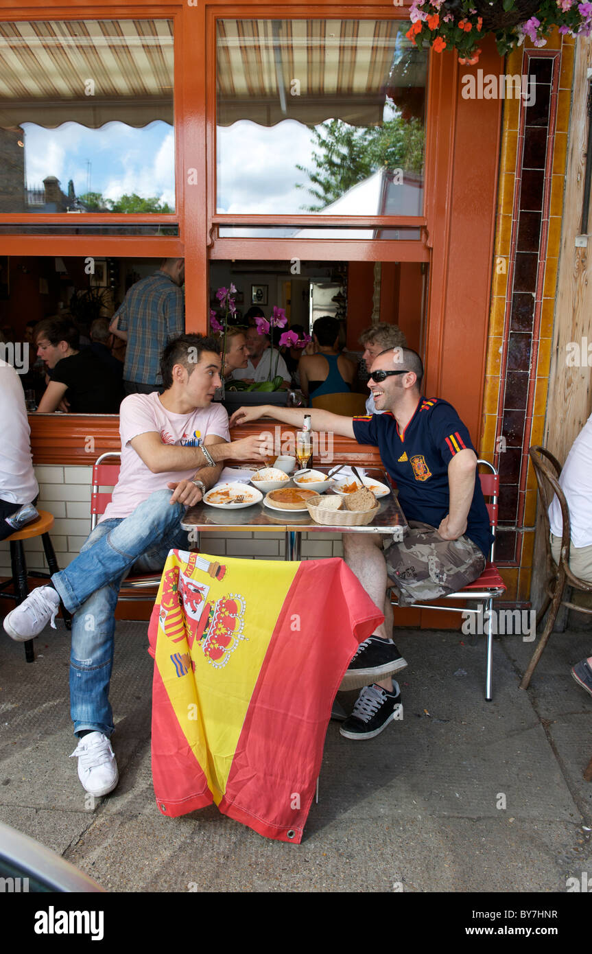 Spanish football fans dine in Columbia Road, Hackney in East London before the World Cup Final July 2010 Stock Photo