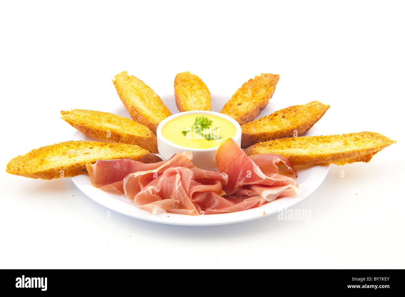 Toast bread, garlic sauce and parma ham . Stock Photo