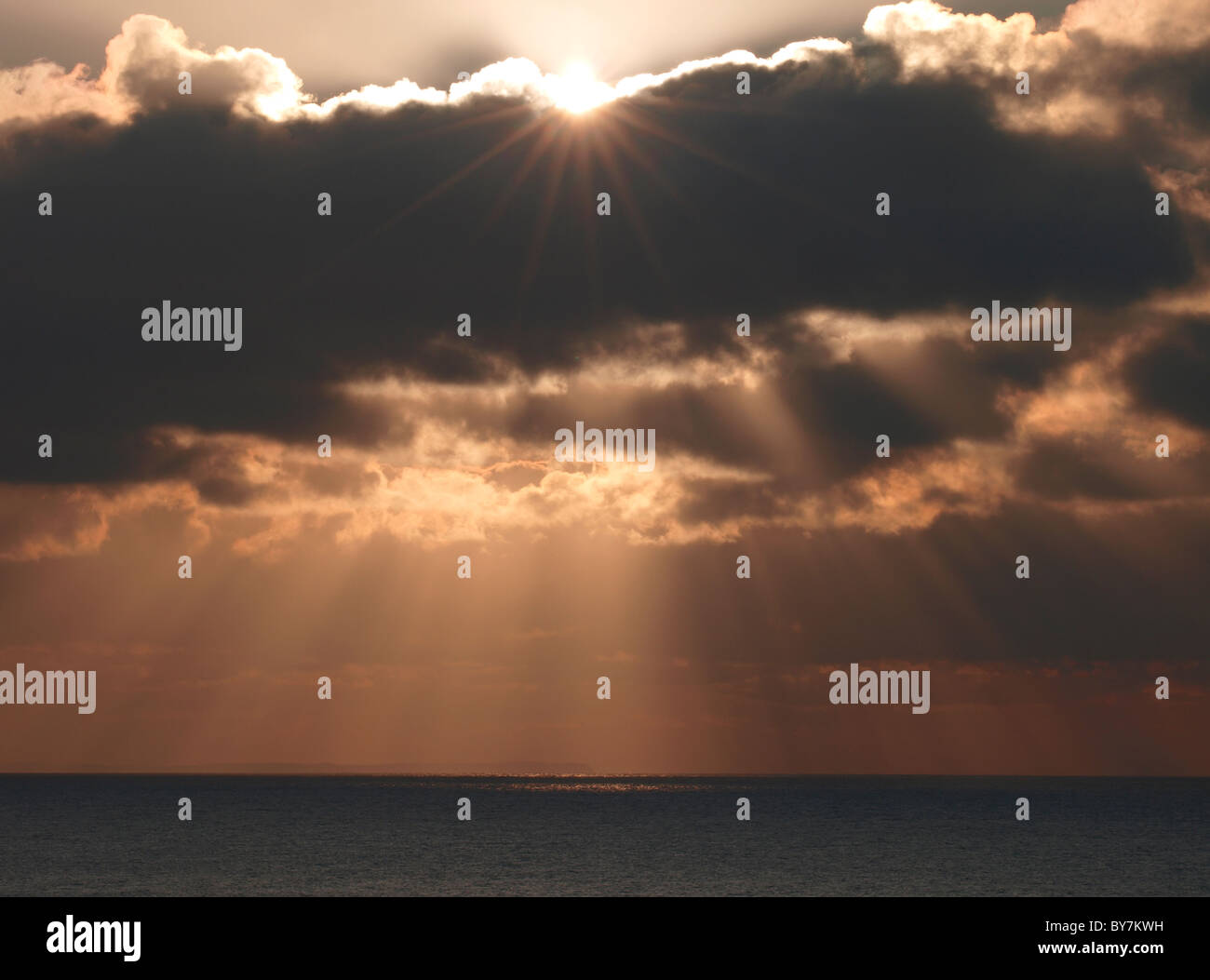 Sun shining through sunset clouds hi-res stock photography and images ...