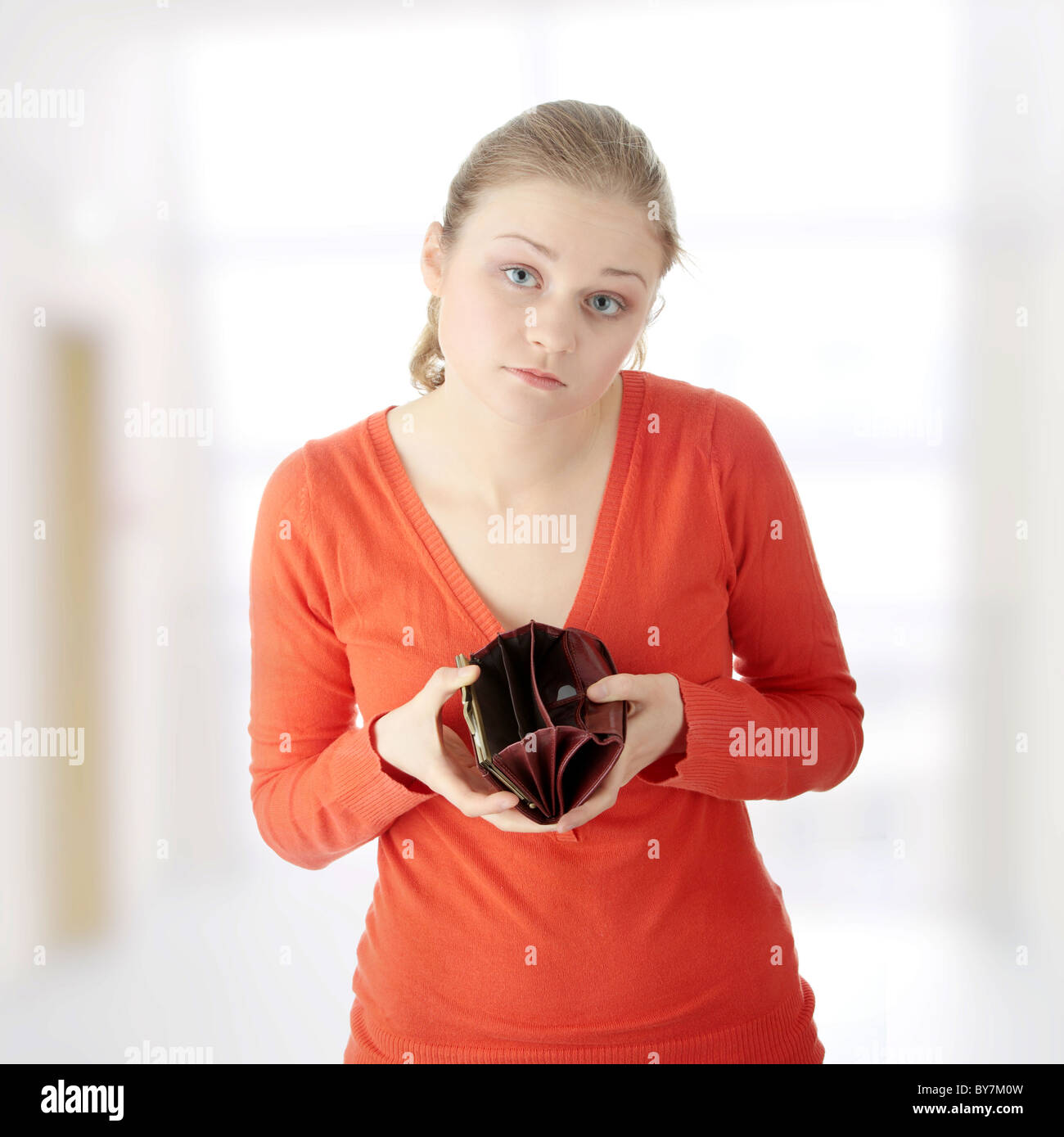 Young woman shows her empty wallet Stock Photo