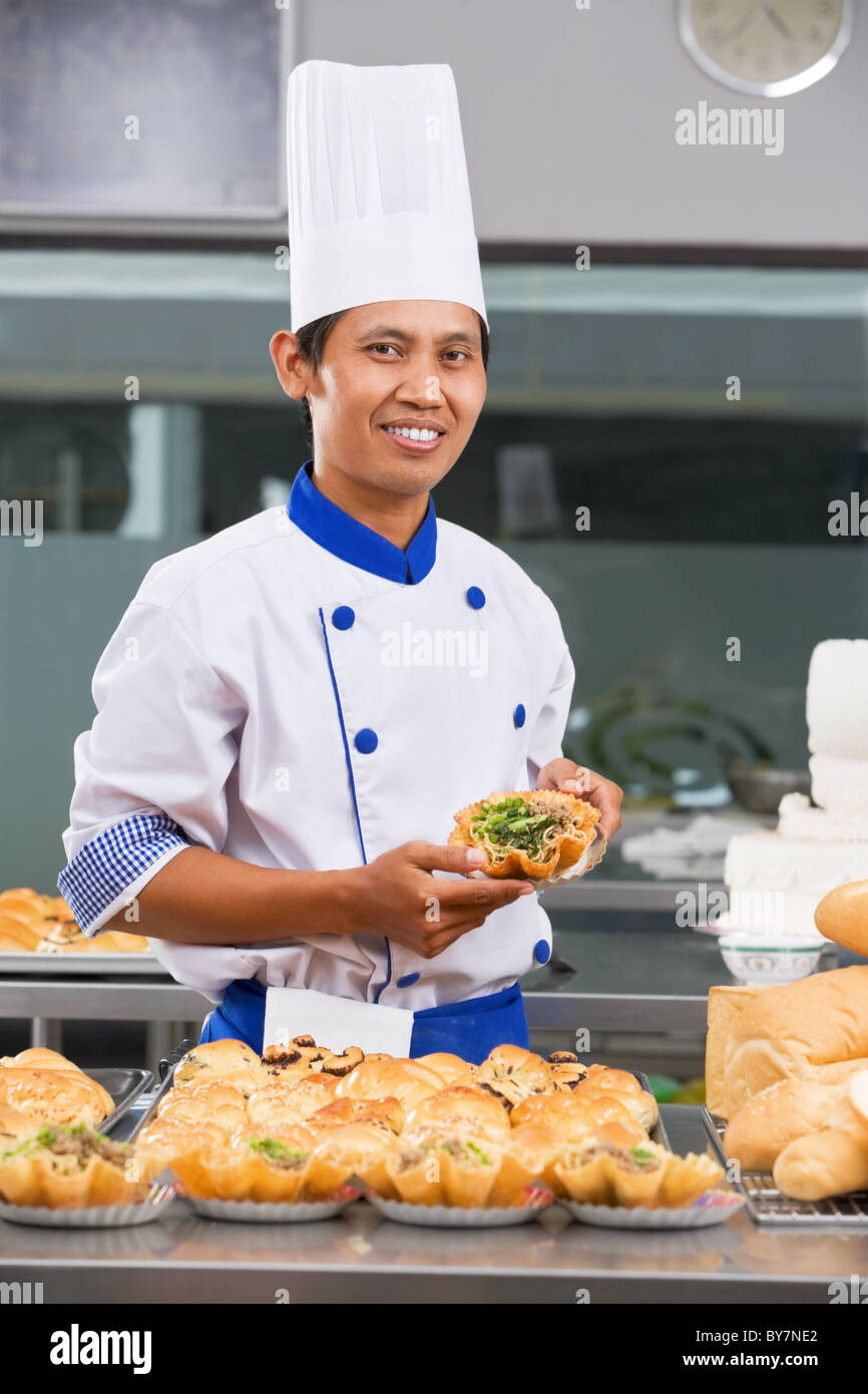 Baker holding the noddle in commercial kitchen Stock Photo