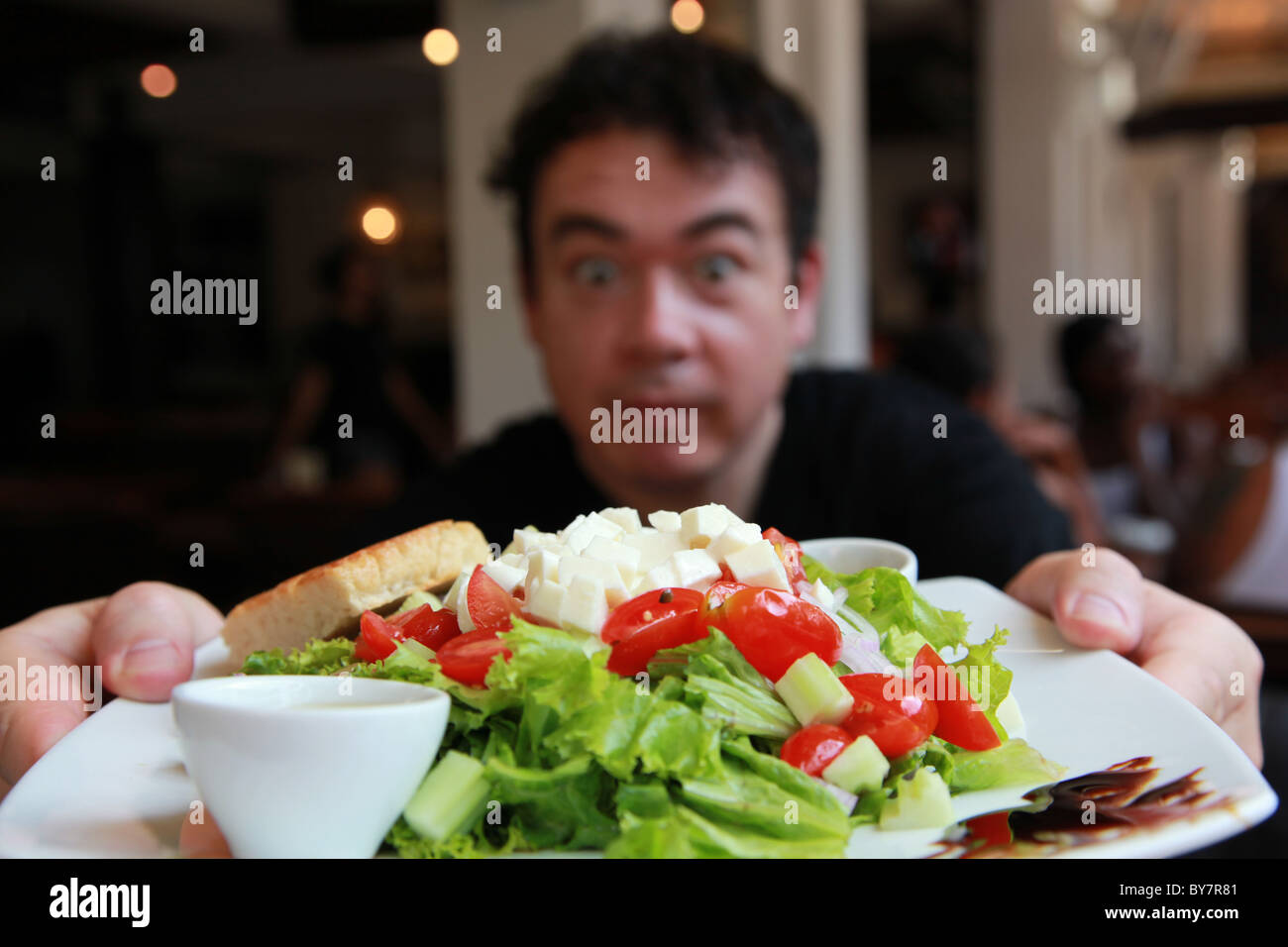 Tourist eating a salad at an open air cafe on Phi PHi Island, Thailand Stock Photo