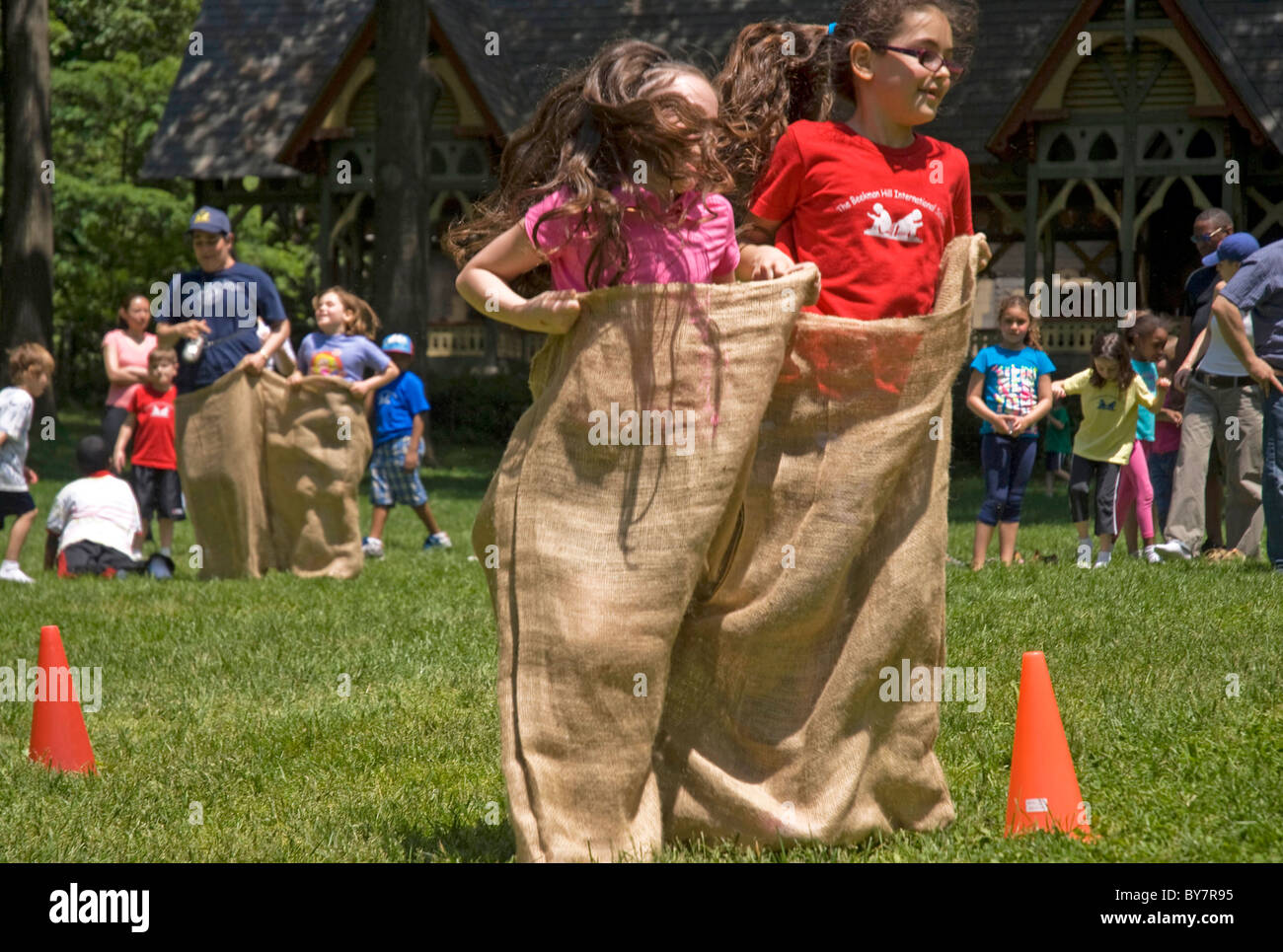 Children having Sack race in the park Stock Photo