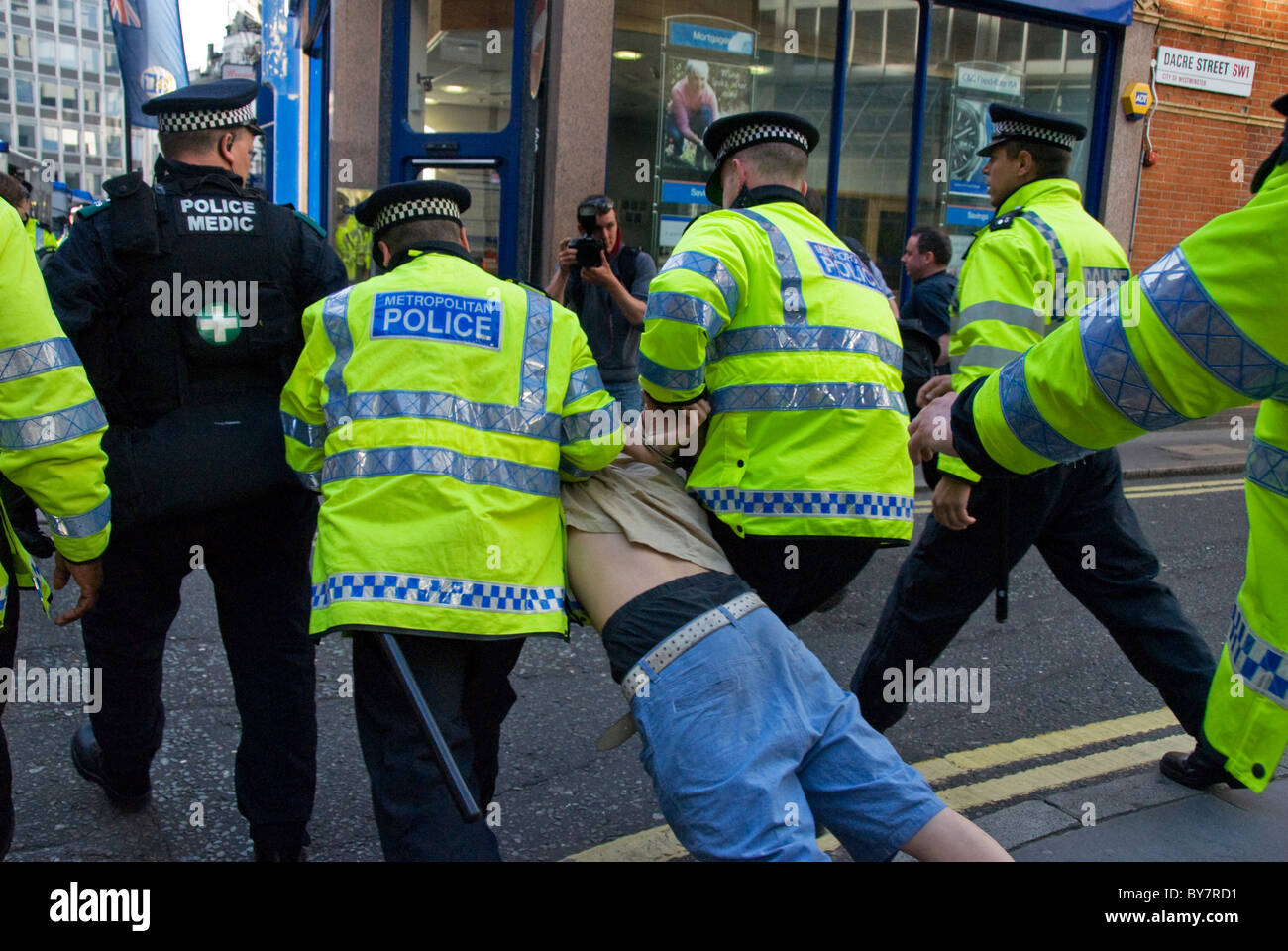 Police arresting protesting youth at demonstration Stock Photo