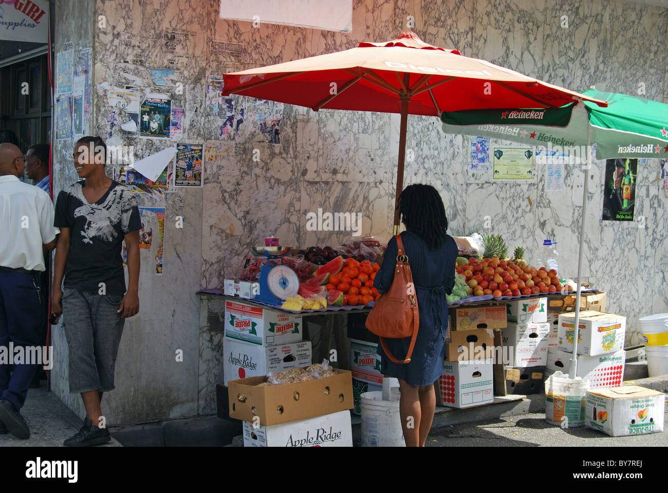 Woman buying fruit from outdoor market stall, Bridgetown, Barbados, Caribbean. Stock Photo
