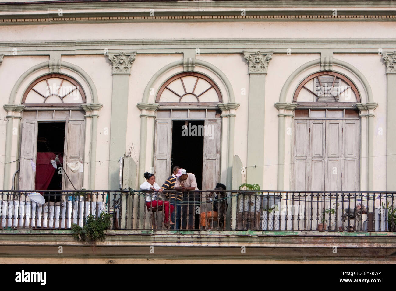 Cuba, Havana. Cubans Enjoying Late-afternoon Conversation on their Balcony. Stock Photo