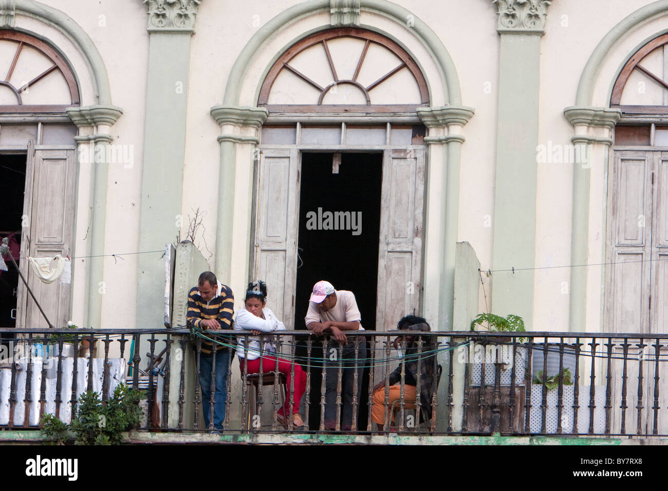 Cuba, Havana. Cubans Enjoying Late-afternoon Conversation on their Balcony. Stock Photo