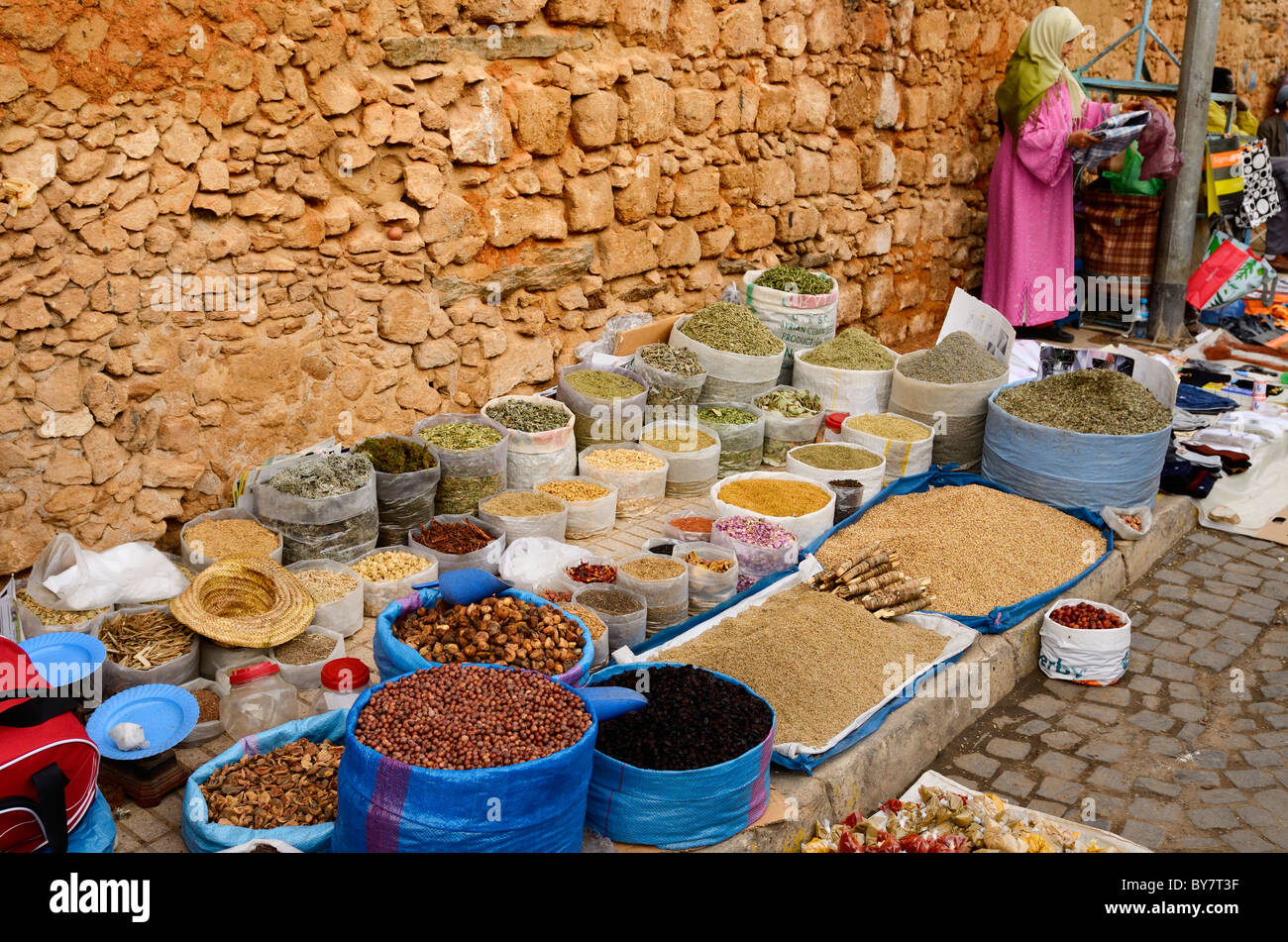 Moroccan vendors selling herbs and goods along the wall of the old Medina Casablanca Morocco North Africa Stock Photo