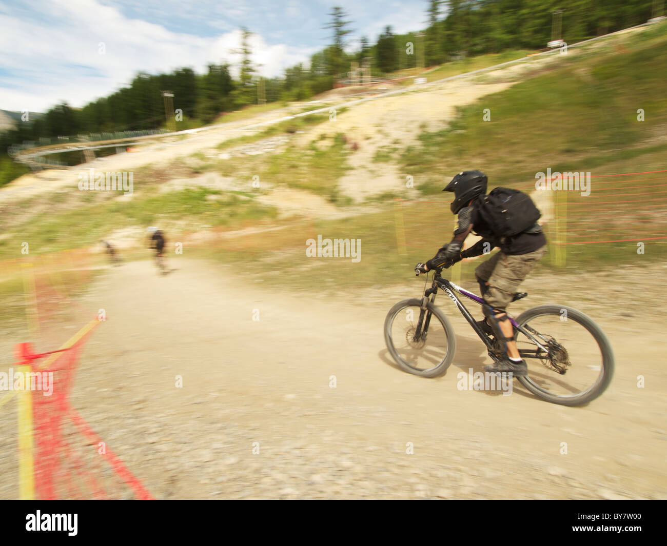 Mountain bikers racing down a slope, Les Orres, French Alps, France Stock Photo