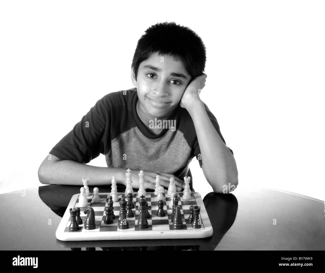 An handsome indian kid playing the game of chess Stock Photo