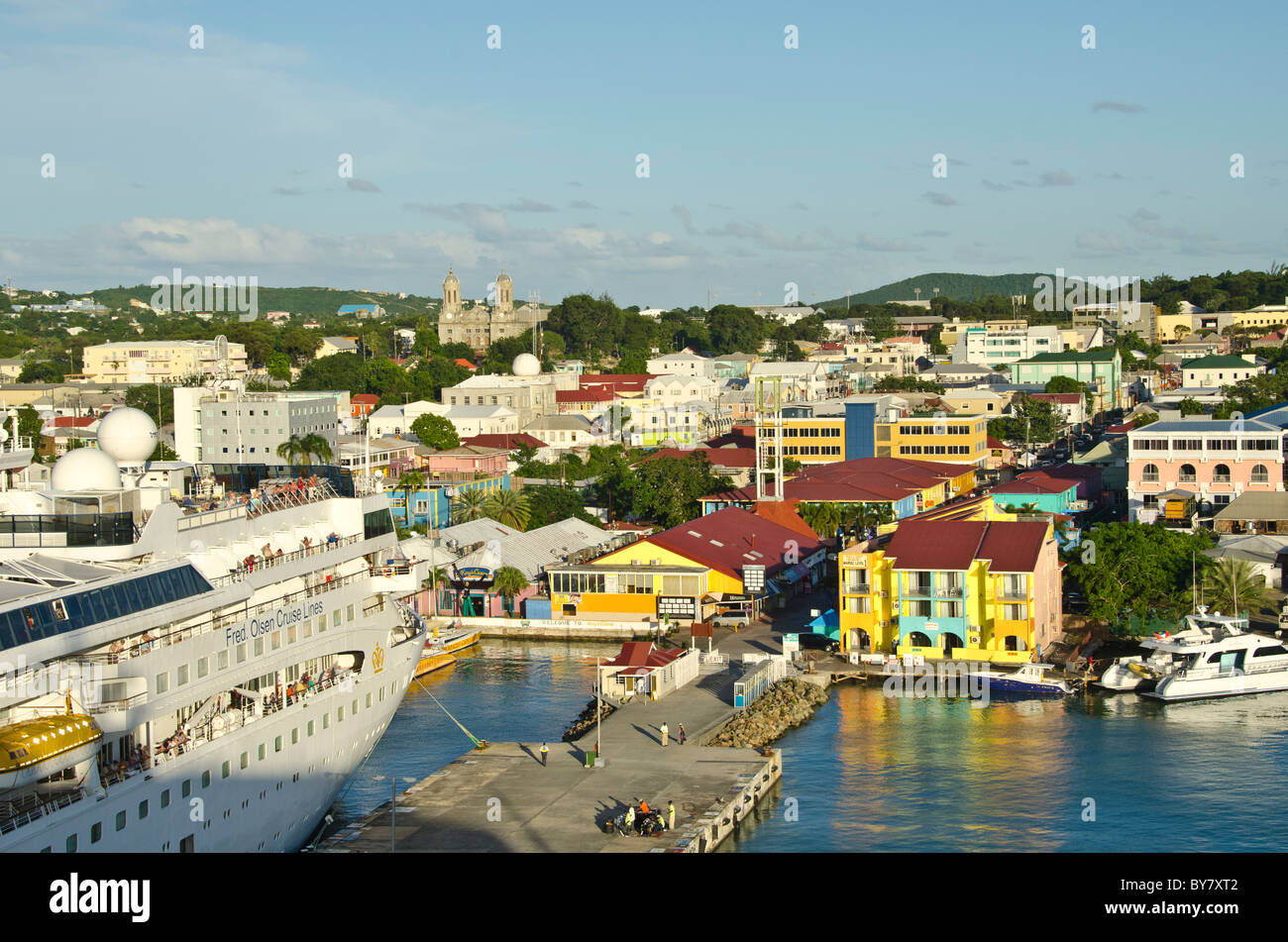 Antigua St. Johns cruise port dock with moored ship and cityscape in bright colors from Caribbean cruise ship Stock Photo