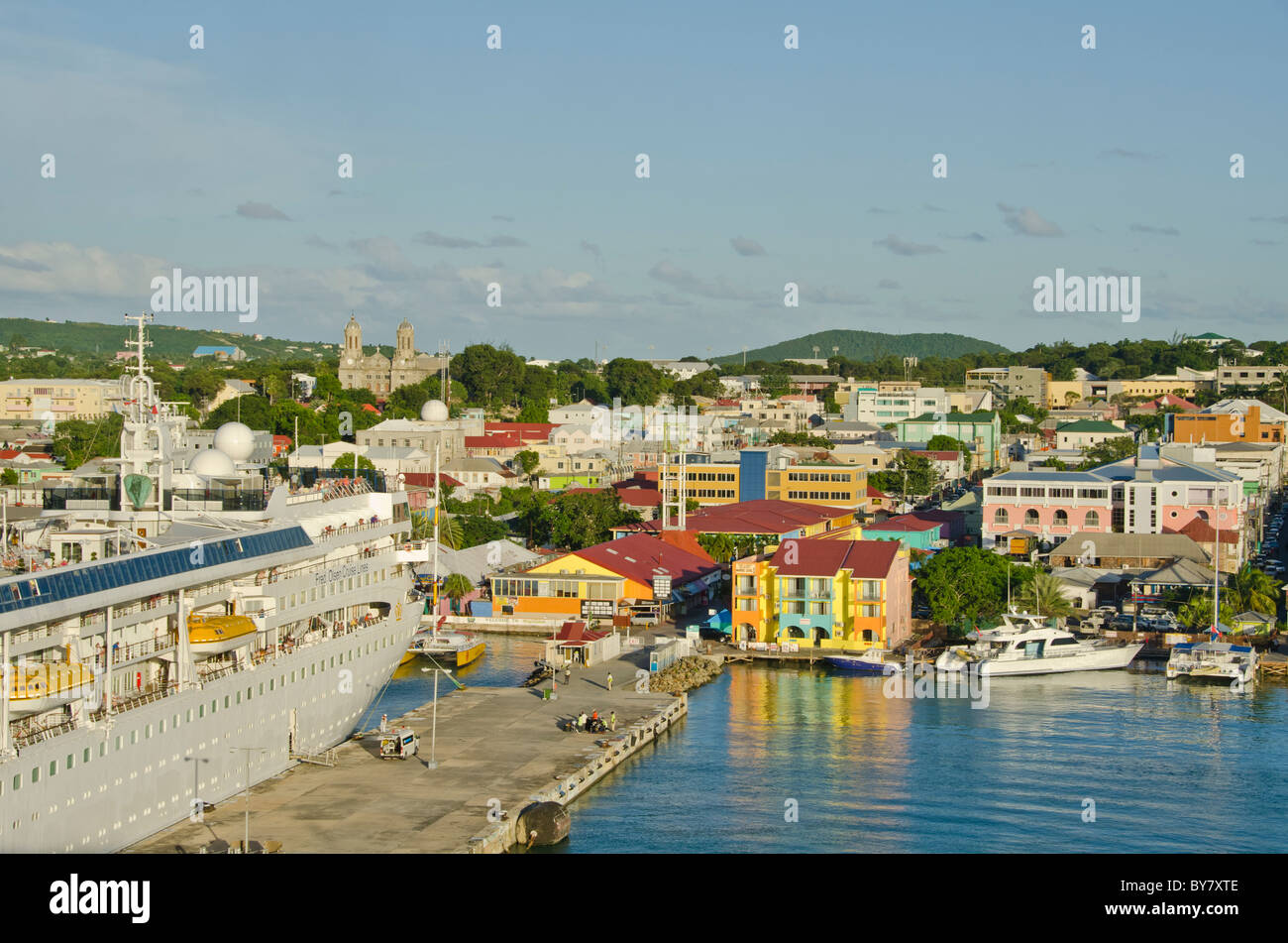 Antigua St. Johns cruise port dock with moored ship and cityscape in