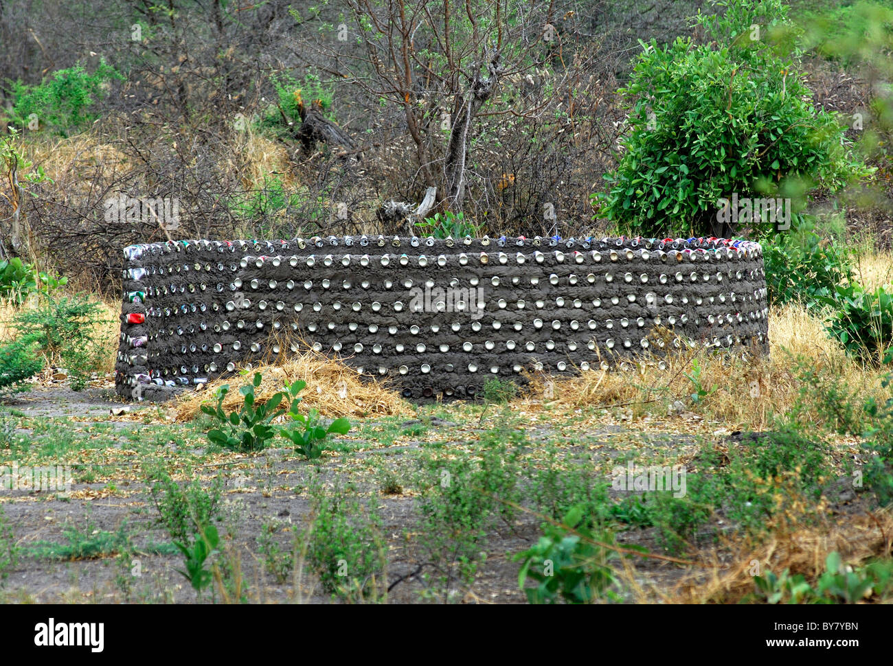Unrendered wall of a round hut under construction made of recycled cans, Khwai Development Project near Maun, Botswana Stock Photo