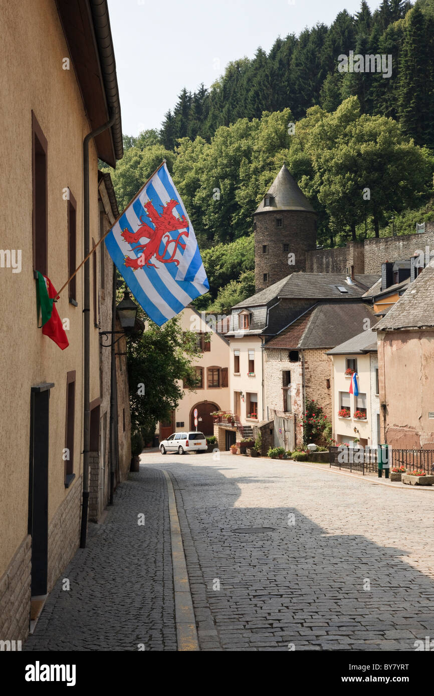 Vianden, Grand Duchy of Luxembourg, Europe. Flag on old houses along the cobbled main street down into the historic town Stock Photo