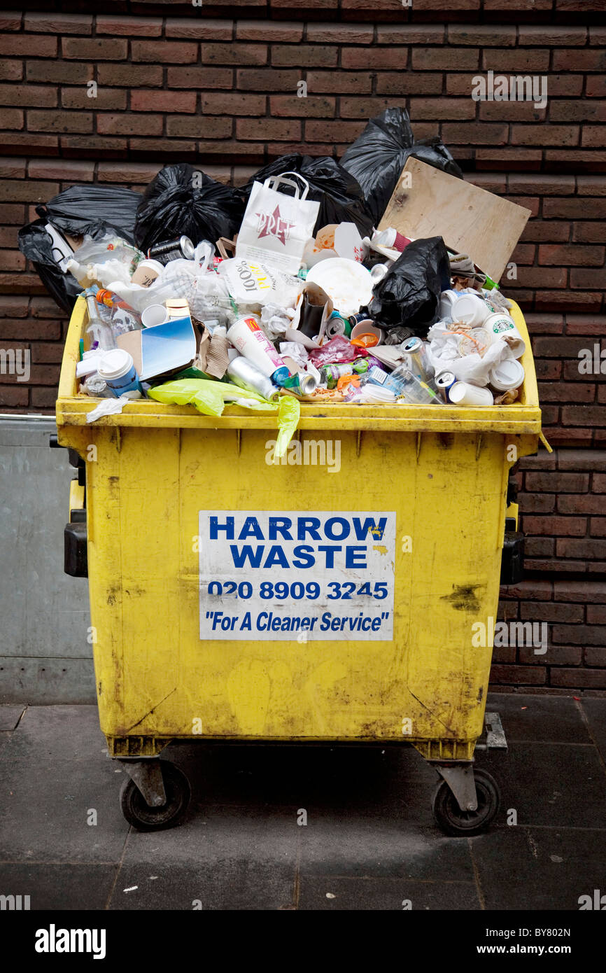 Recycling bins overflowing with rubbish. Designed to recycle waste, these bins are now loaded