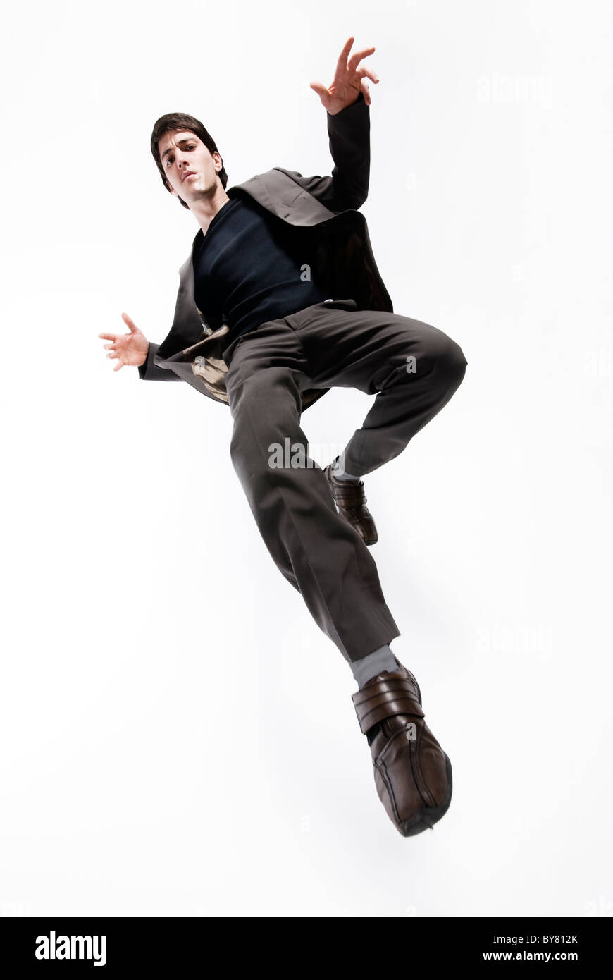 Businessman Jumping in Mid Air Stock Photo
