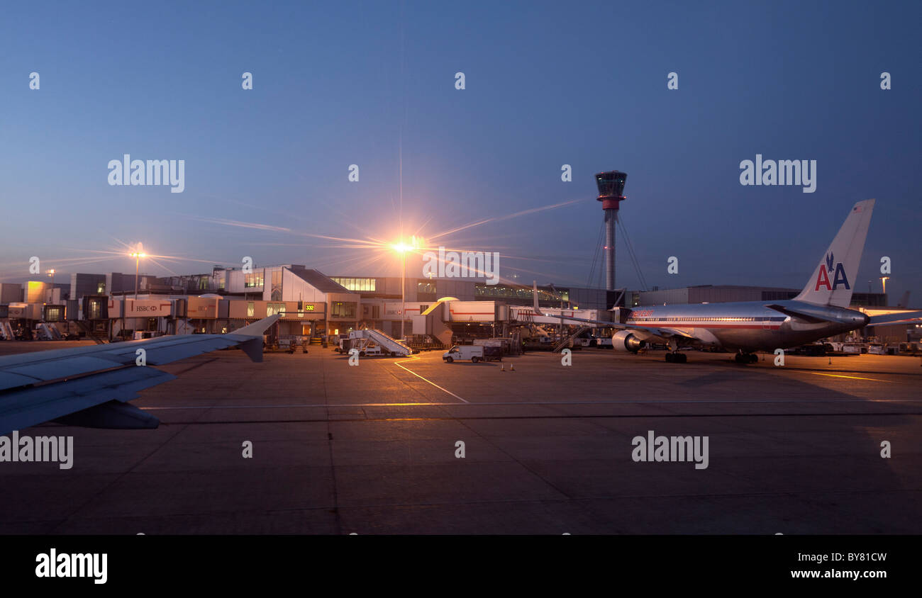 airport control tower and airplanes parked on the early morning Stock Photo