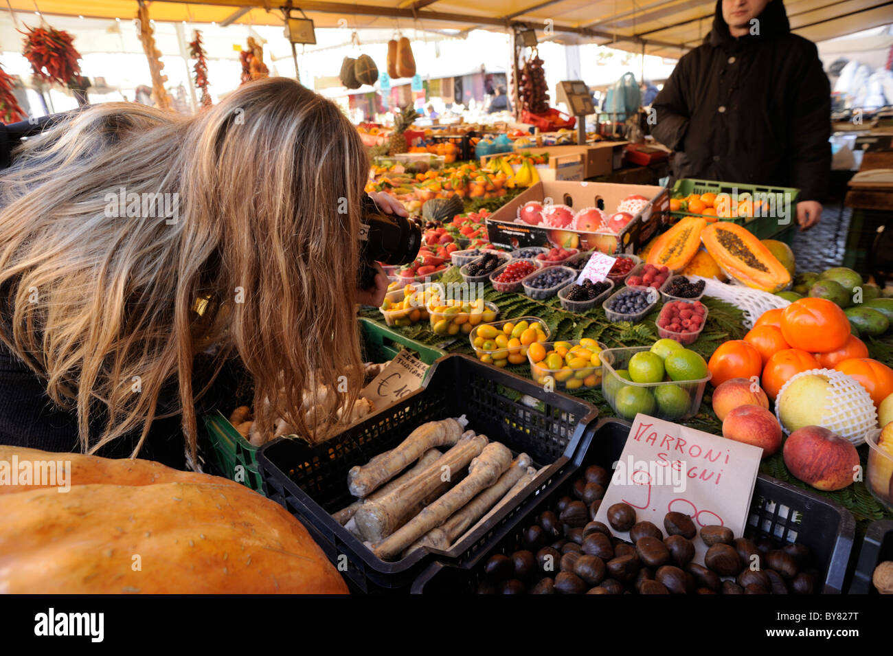 Italy, Rome, Campo de' Fiori, market stalls, girl taking pictures of food Stock Photo