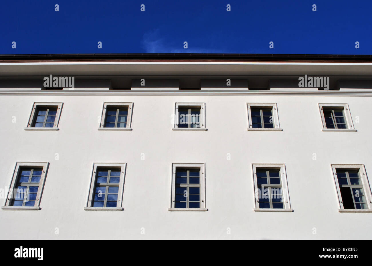 building with windows and blue sky background Stock Photo - Alamy