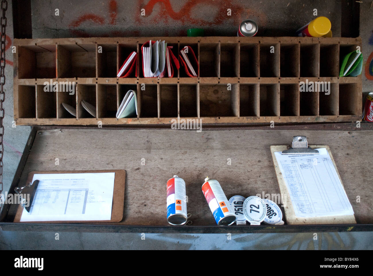 Items for paperwork in pigeonholes and makeshift workbench. Stock Photo