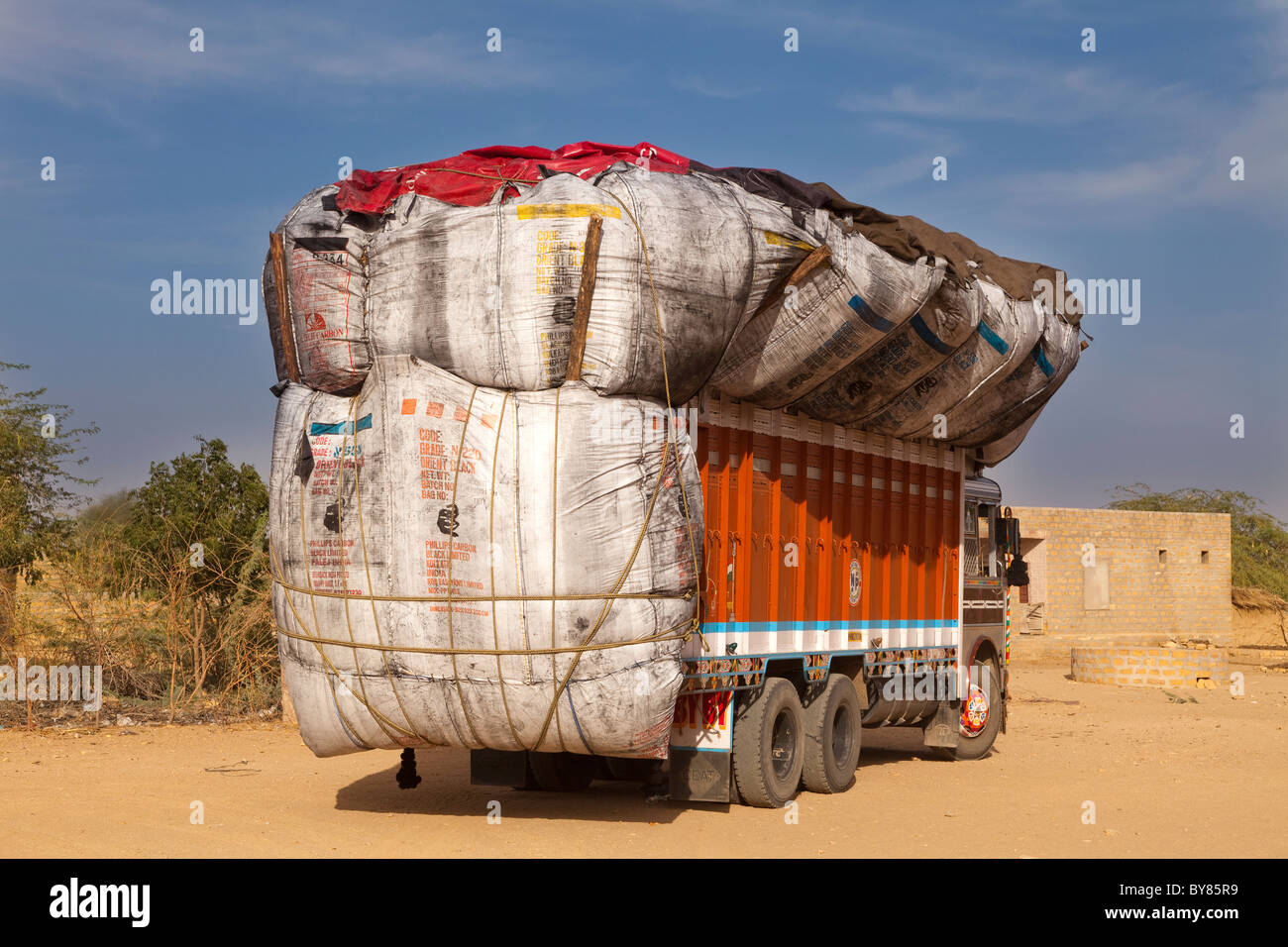 India, Rajasthan, Overloaded goods lorry with bald tyres and no rear reegistration plate Stock Photo