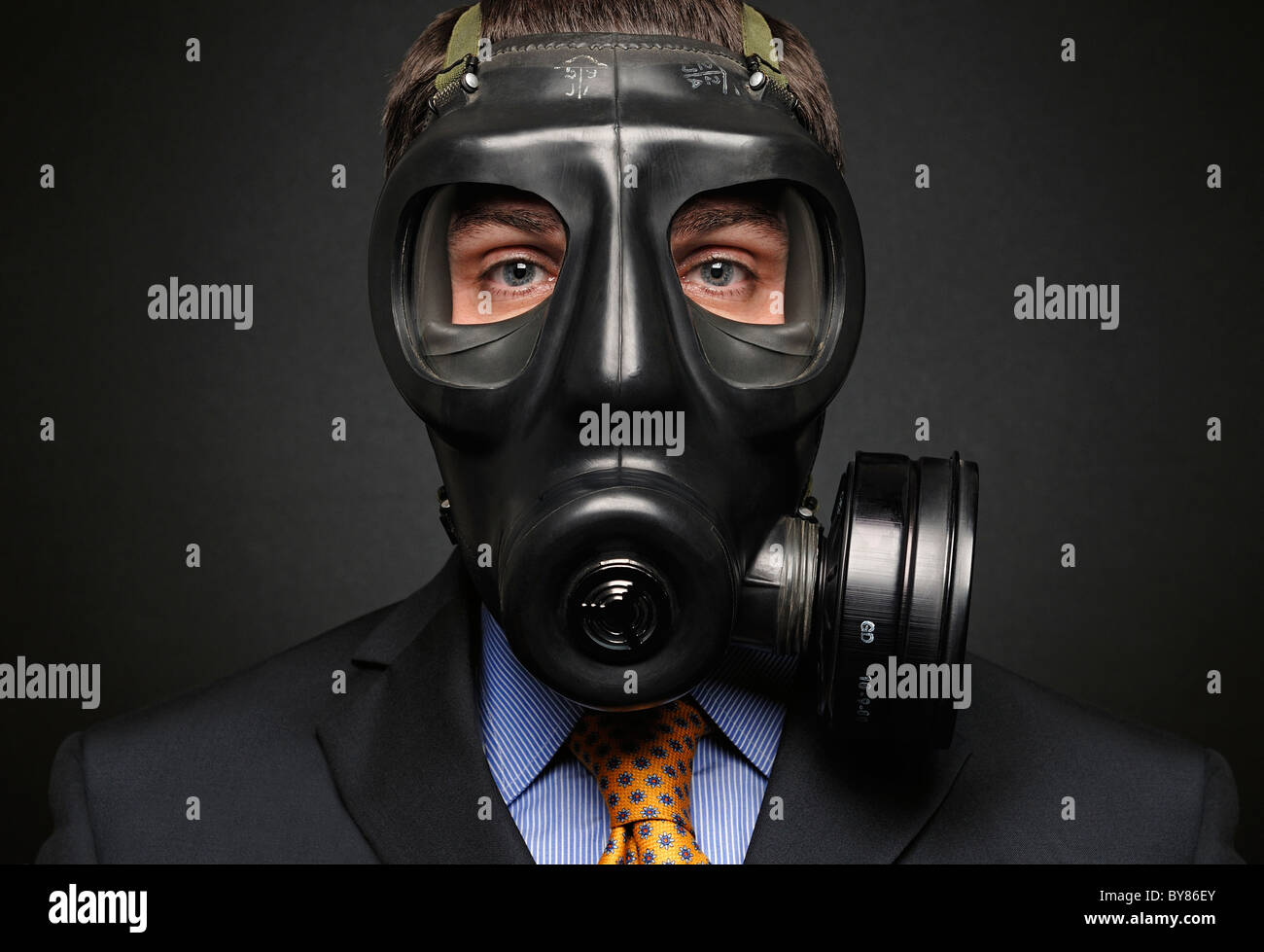 Businessman Wearing Gas Mask Stock Photo