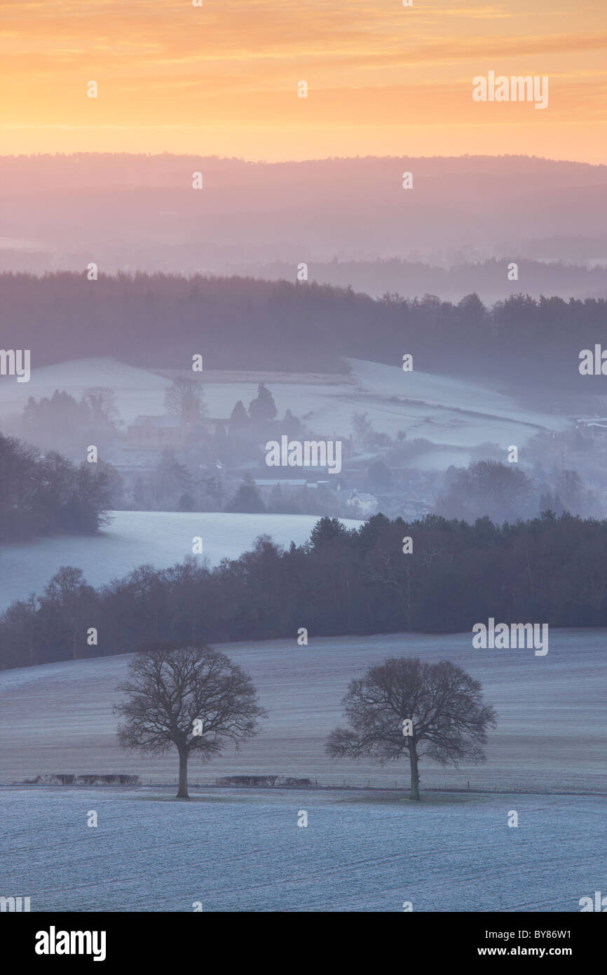 View from Newlands Corner overlooking Albury. A covering of frost and pockets of morning mist floating between the distant hills Stock Photo
