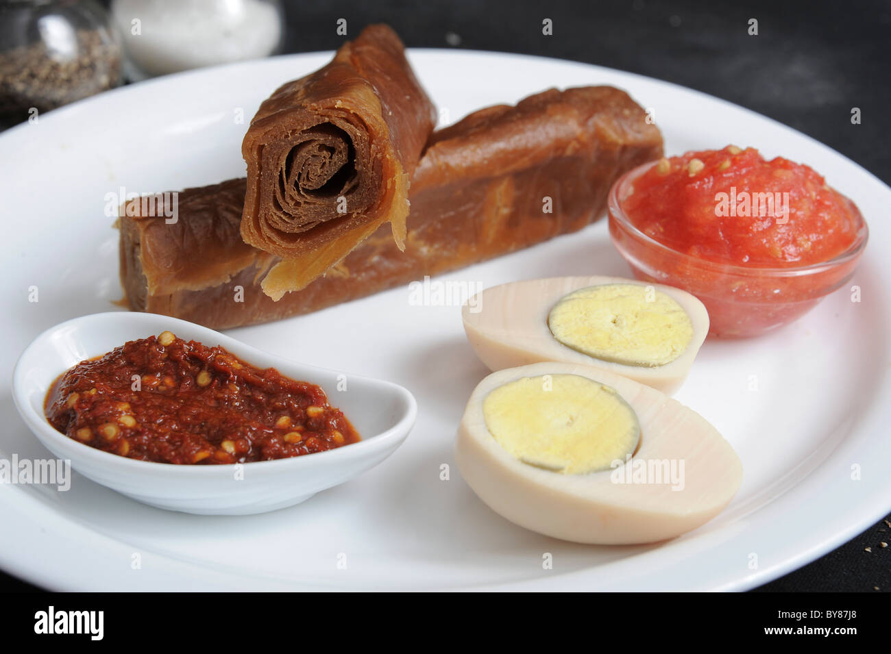 Jachnun with tomato, hard boild egg and Skhug Stock Photo