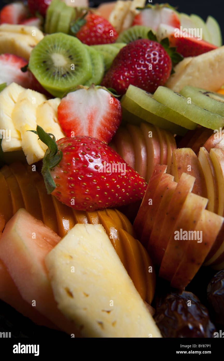 Freshly cut fruit salad with kiwi, pineapple, strawberries and melon Stock Photo