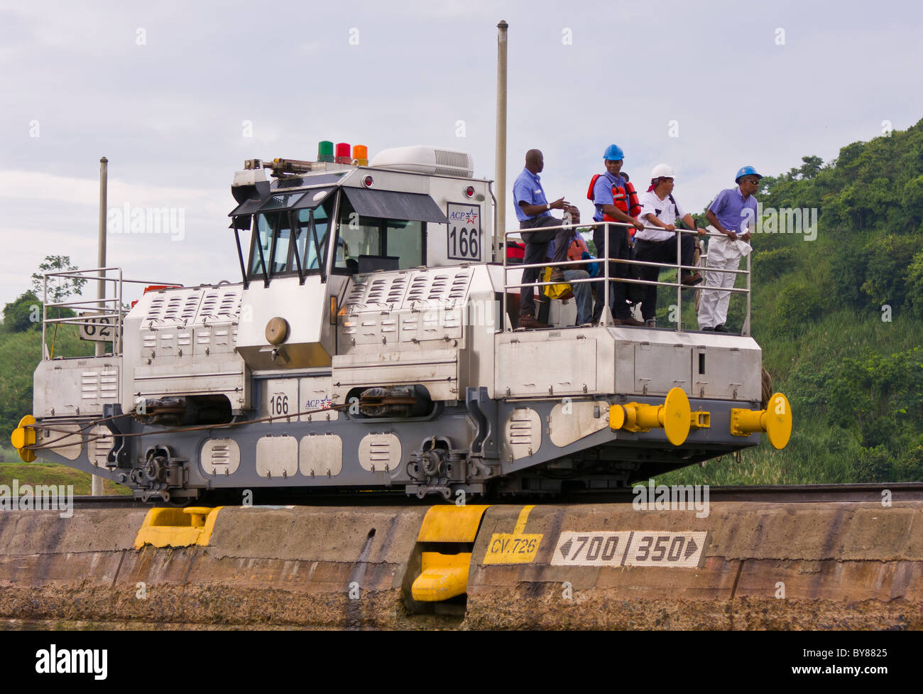 PANAMA - Workers and electric locomotive also known as a mule, Miraflores Locks on Panama Canal. Stock Photo