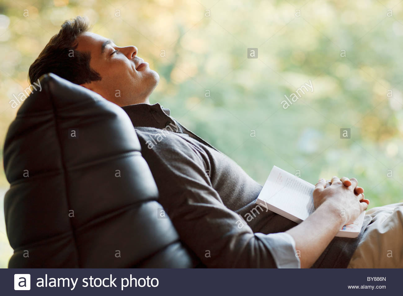 Man Sleeping On Lounge Chair Stock Photos & Man Sleeping On Lounge
