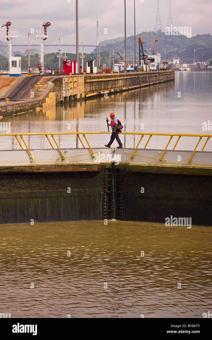 PANAMA - Worker crosses top of lock doors at Miraflores Locks on Panama Canal. Stock Photo