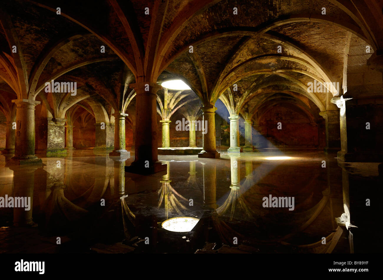 Shaft of light from skylight in underground Portuguese cistern ancient armory water reflection in the old city of El Jadida Morocco Stock Photo