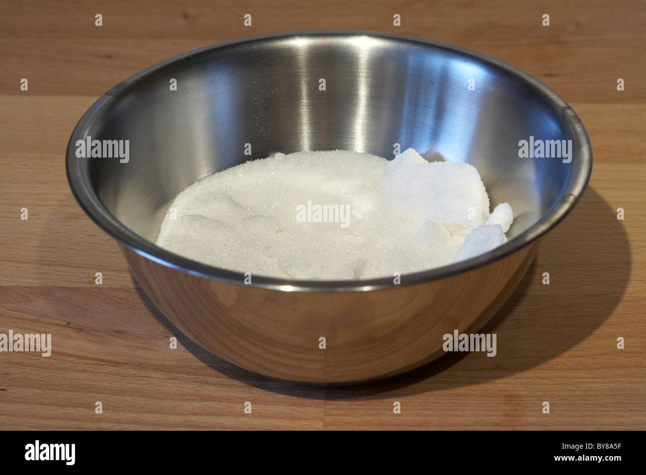 amount of caster sugar in a metal mixing bowl Stock Photo
