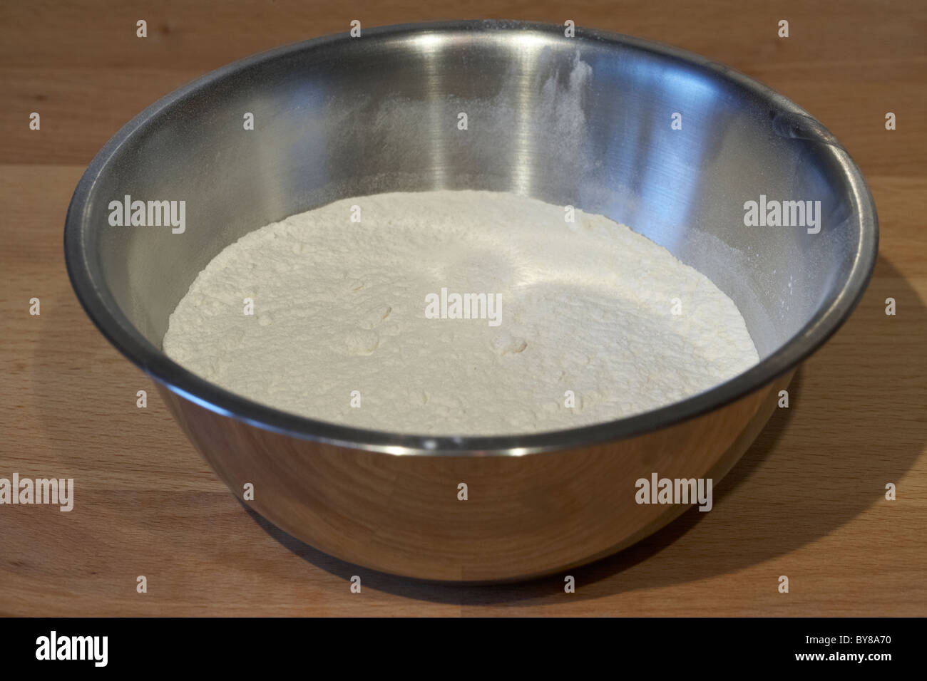 measured amount of self raising flour in a metal mixing bowl for baking Stock Photo