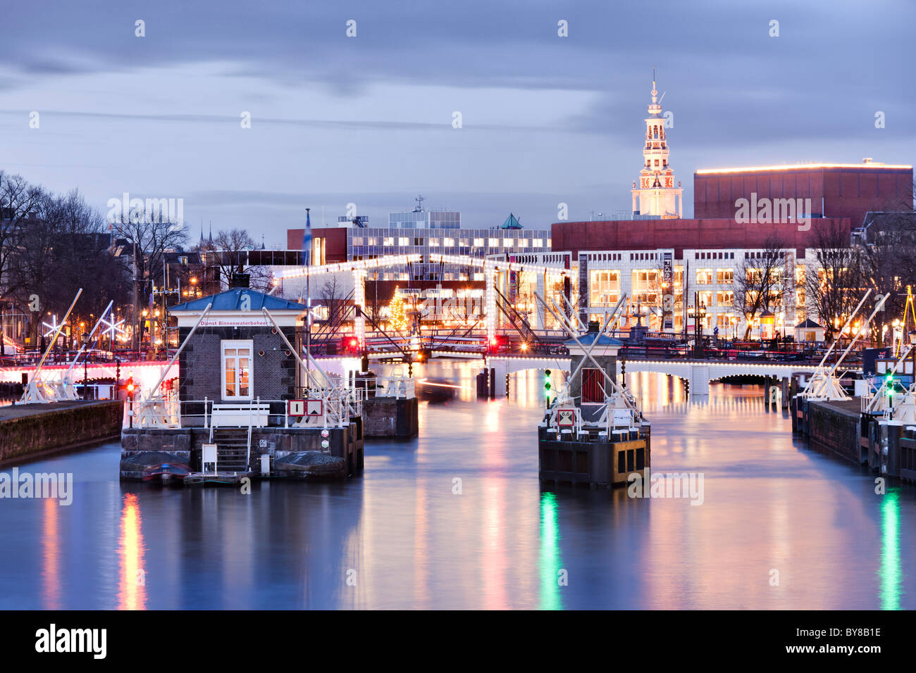 Amsterdam Amstel River with Skinny Bridge, Magere Brug and Muziektheater, Opera House at dusk in winter. Stock Photo
