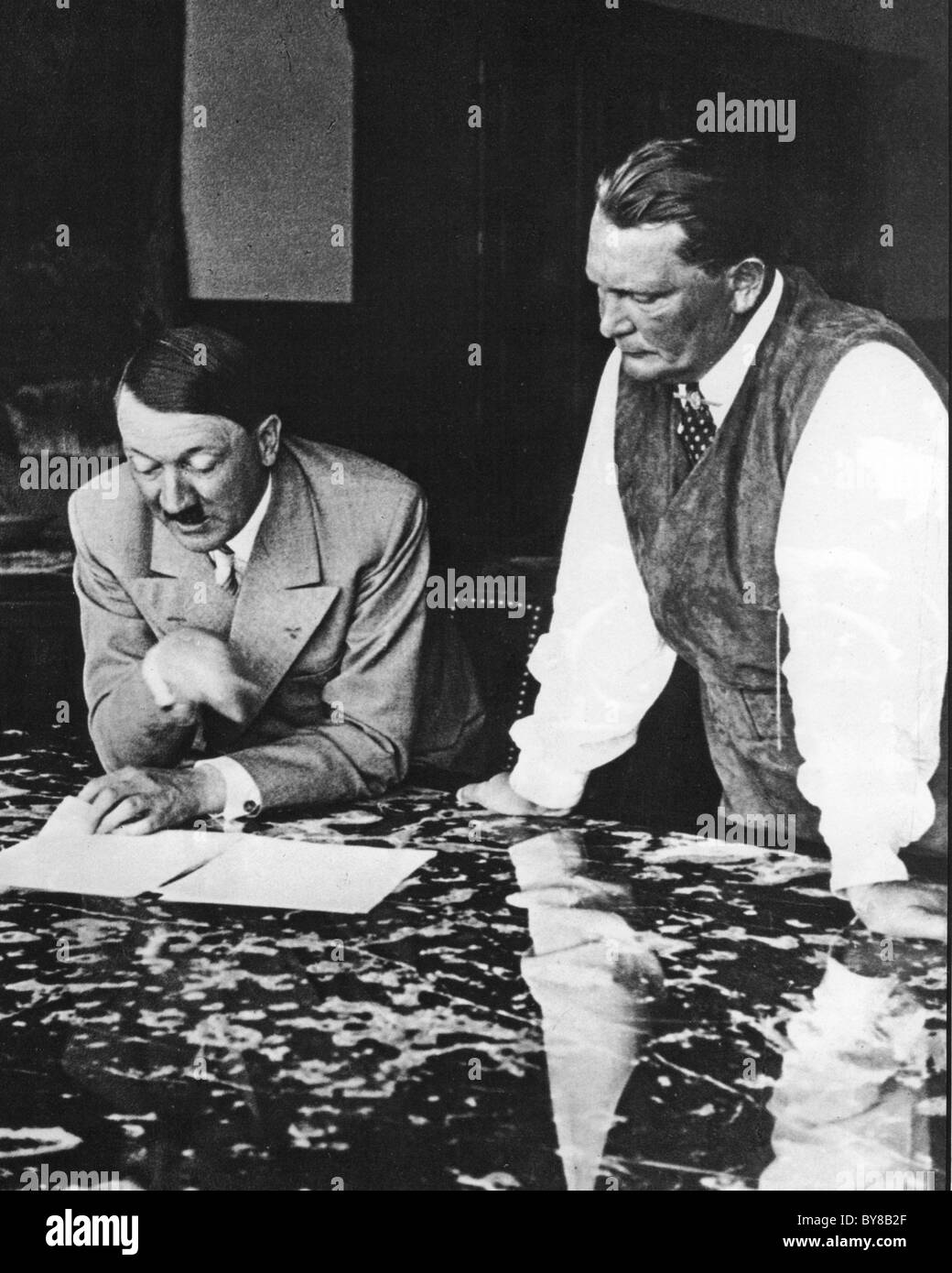HERMAN GOERING watches Adolf Hitler leafing through documents at Goering's Karinhalle home about 1938 Stock Photo